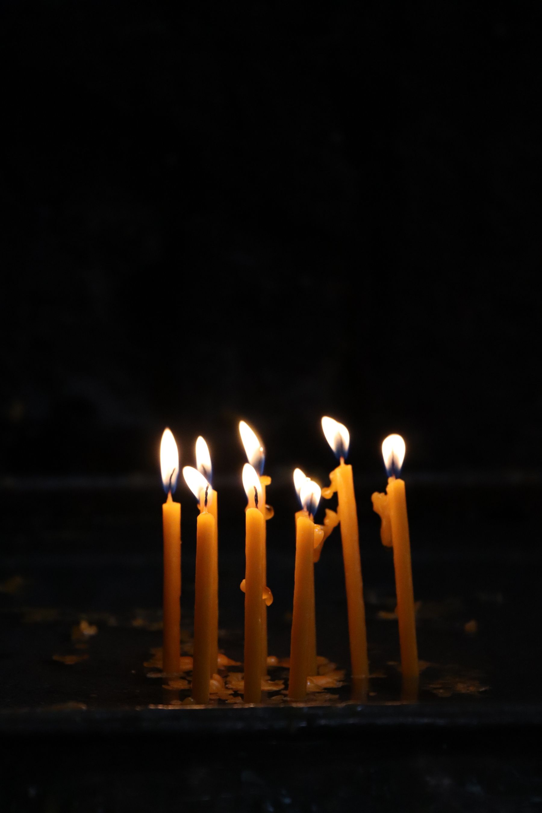 Candles lit in a darkened room